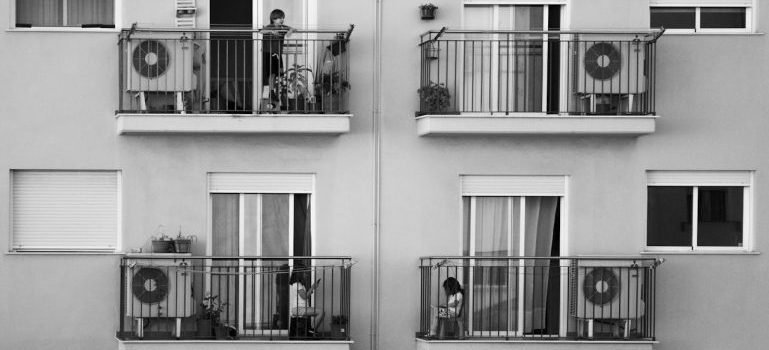 Children playing on balconies of a modern building