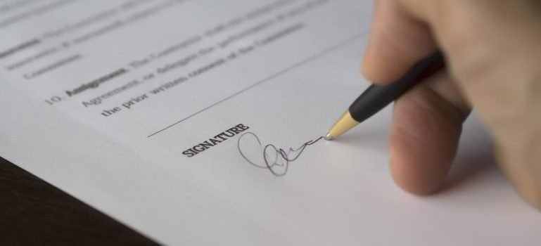 A person signing a document.