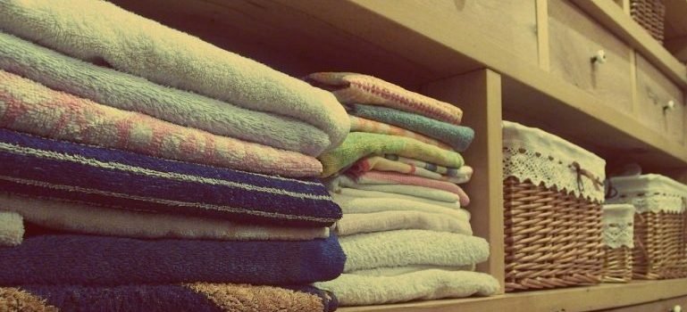 A stack of towels on the rack as one of the method to maintain your Manhattan apartment clutter-free