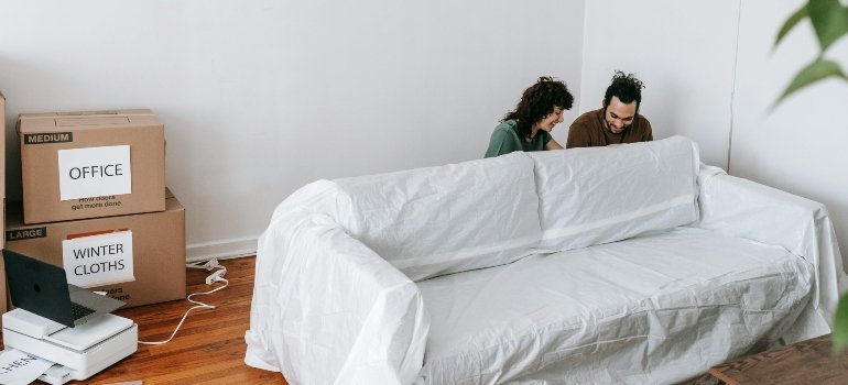 A couple behind a couch