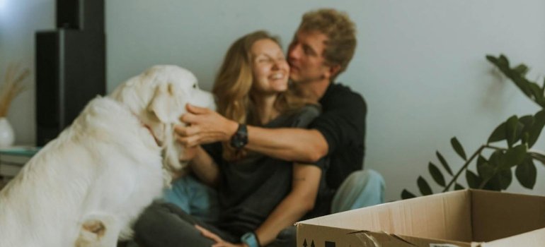 A couple being happy at home after trying to discover Manhattan's top dog-friendly neighborhoods