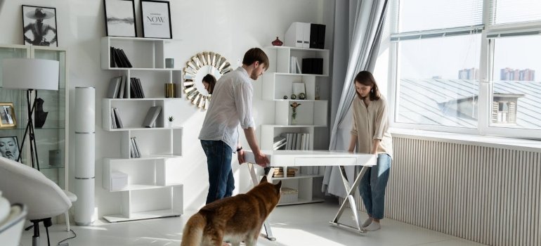 A man and a woman and their dog enjoying their new life after having to discover Manhattans top dog-friendly neighborhoods