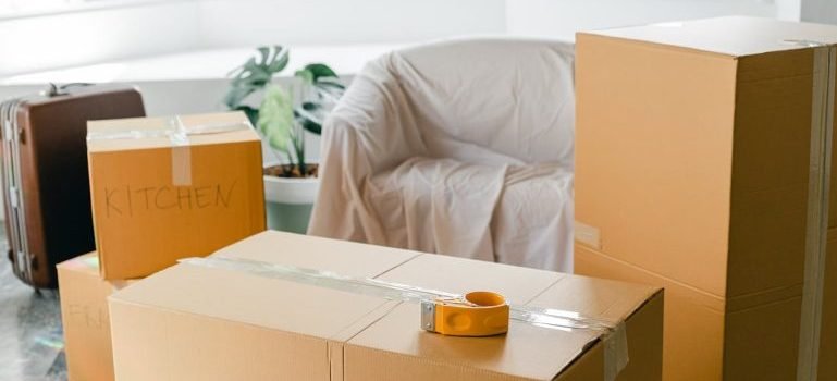 Cardboard boxes next to a sofa.