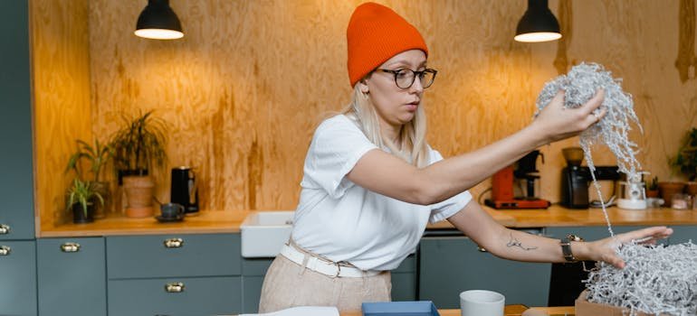 A woman with red cap using technology to declutter paperwork