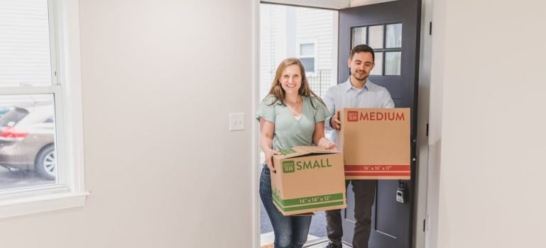 A man and a woman with boxes preparing for living in Long Island City