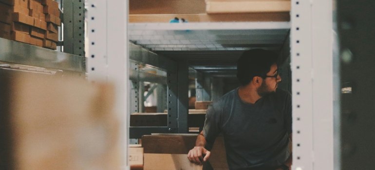 a man in a storage room Comparing renting storage and in-house storage solutions