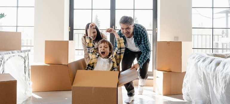 A happy family unpacking and celebrating after buying an apartment in the Bronx.