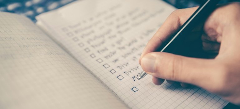 A person completing a checklist while trying to prevent clutter after moving to the Bronx.
