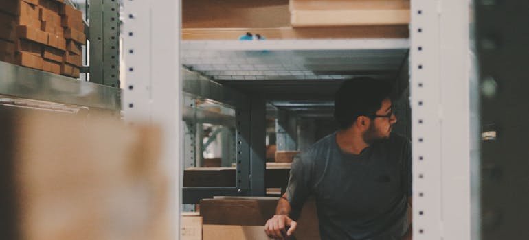 A man in between shelves in an ideal business storage unit in Manhattan.