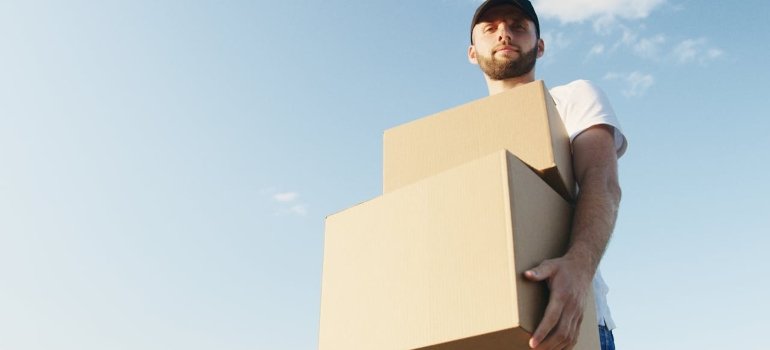 Person carrying boxes to one of the storage Jackson Heights NY facilities.