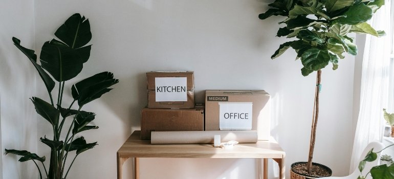 A desk with boxes ready for the storage Williamsburg NY locals recommend.