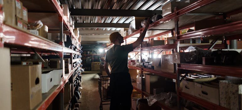 A man rearranging shelves.