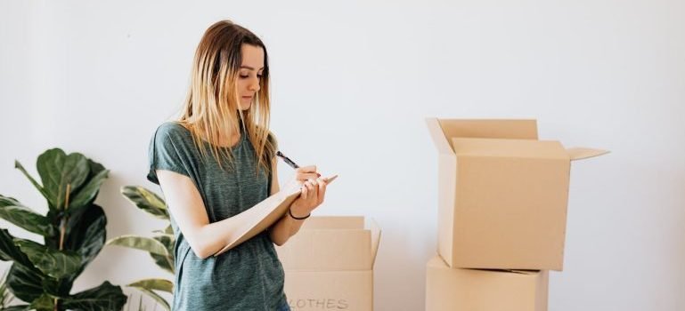 A woman writing down a comprehensive storage inventory