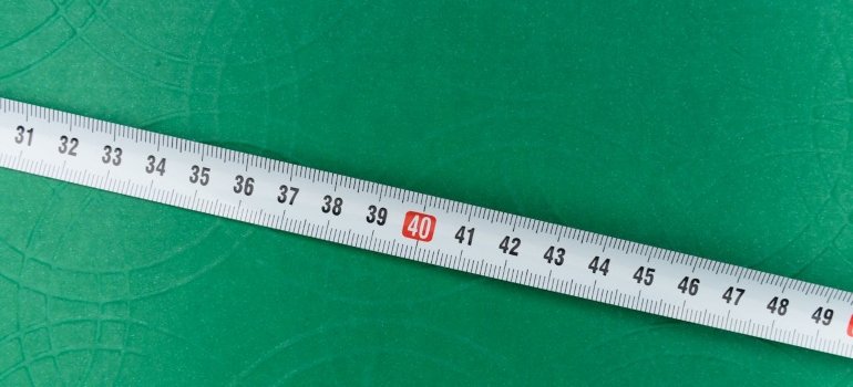 A measuring tape on a green surface