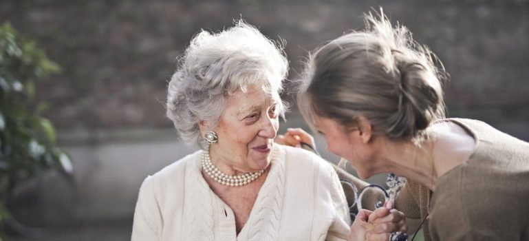 young woman and old woman talking