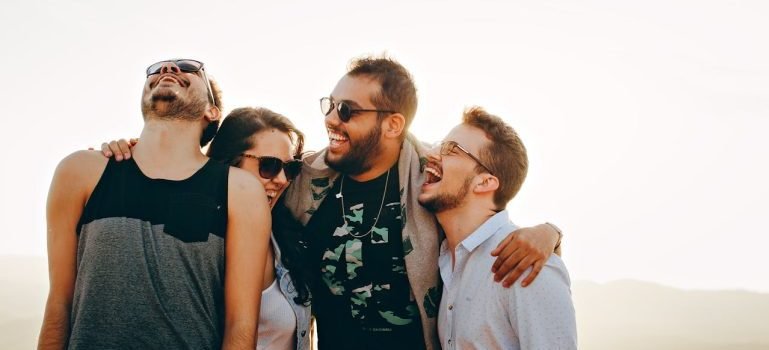 A group of people smiling while trying to build social connections after moving to the Bronx.