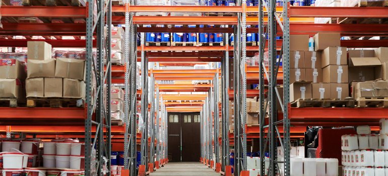 An organized warehouse with shelves filled with boxes and items.