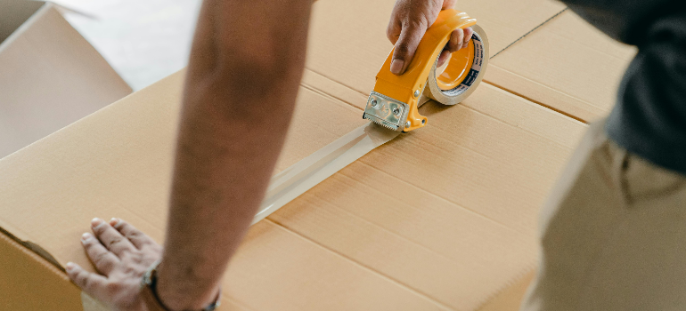 A man taping a box and after exploring the storage solutions gaining popularity