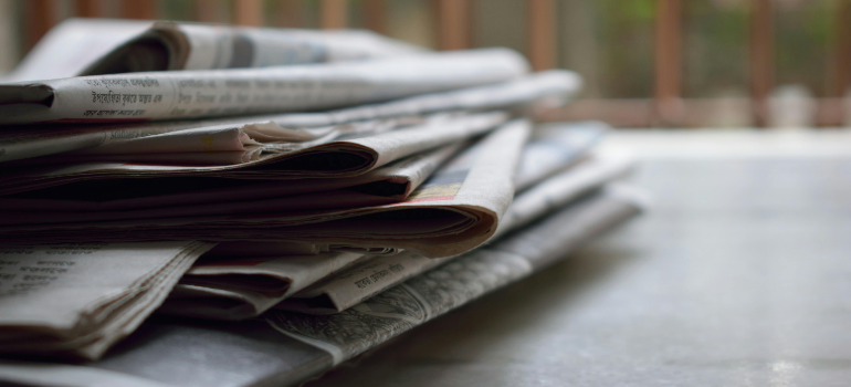 A pile of newspapers which are budget-friendly packing materials