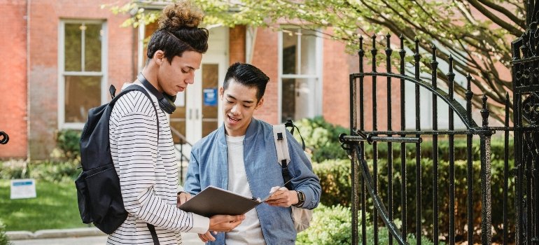 Two roommates talking to each other about university.