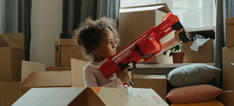 a girl playing in a moving box
