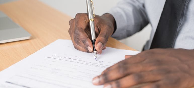 A person signing a document.