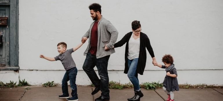 A family of four taking a walk down the street as you will do once you decide which Brooklyn neighborhood is reight for you.