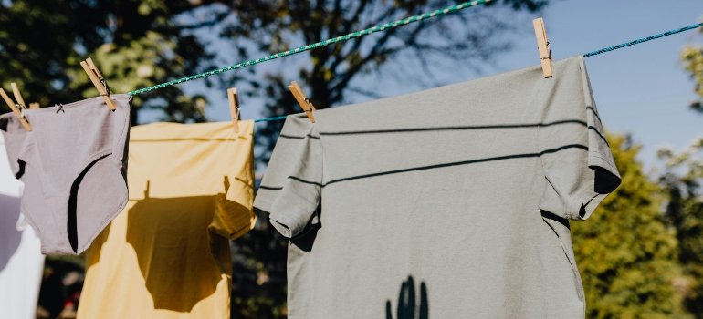Clothes drying on a rope with clothespins in the garden.