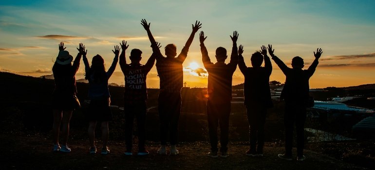 People jumping in the sunset.