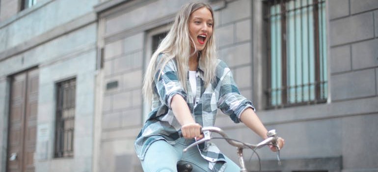 A woman having fun while biking to work as this is the way to survive the daily commute to work in NYC