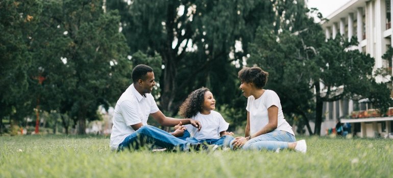 A family laughing in nature after starting a new life in the Bronx.