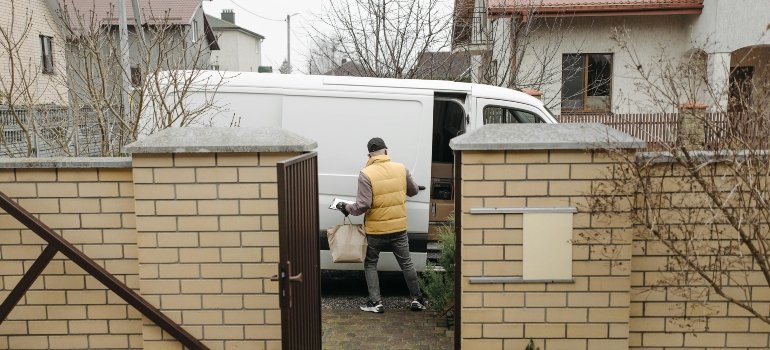 A mover opening a moving van before entering the yard.