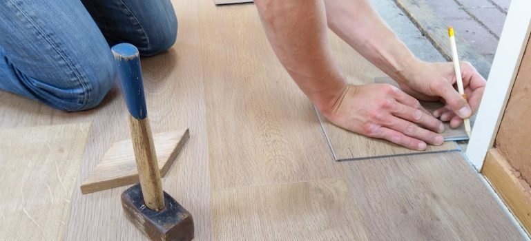 A man renovating floor after reading about how long-term storage can transform your home