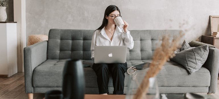 A young woman drinking a coffee and researching her options online