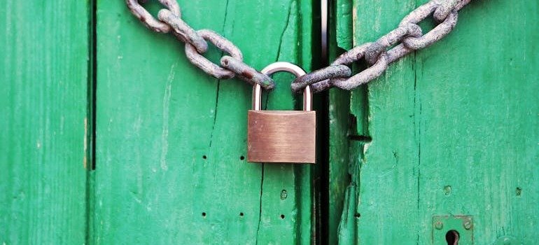 A padlock on a green door.