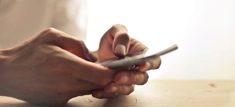 A person using a phone to find out why NYC businesses rely on storage units.