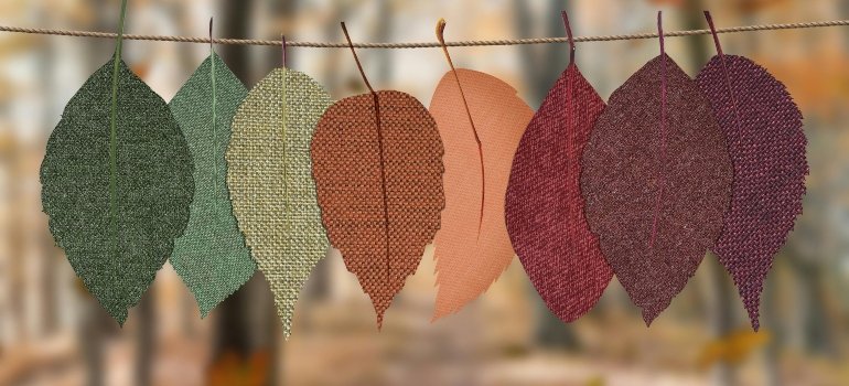 Colorful fabric leaves hanging on a string, illustrating seasonal transitions, much like how storage costs vary across NYC with time.