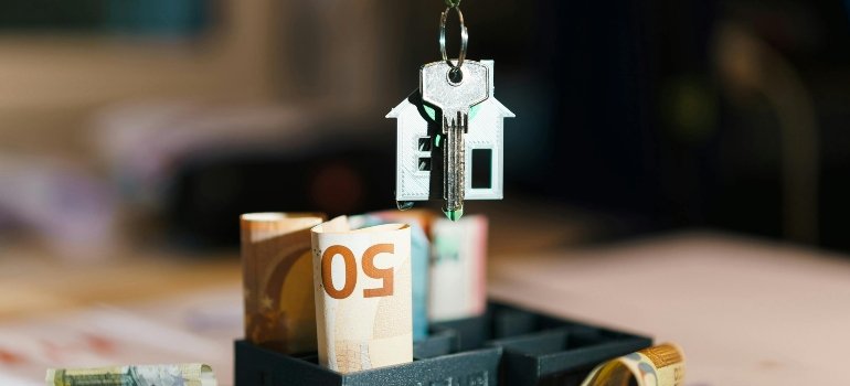 House key with euro bills, symbolizing the Bronx's affordable housing market.