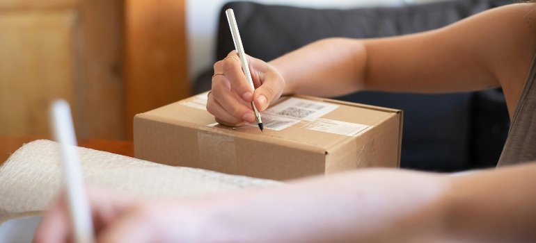 A woman packing boxes for moving.