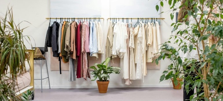 Seasonal clothing on racks with a modern storage layout, ideal for maintaining fabric quality with climate-controlled storage in NYC.