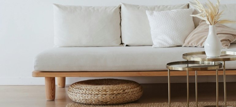 White couch on wooden floor.