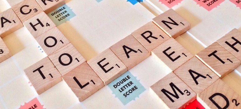 Scrabble tiles spelling 'Learn' and 'School,' symbolizing the educational opportunities in the Bronx.