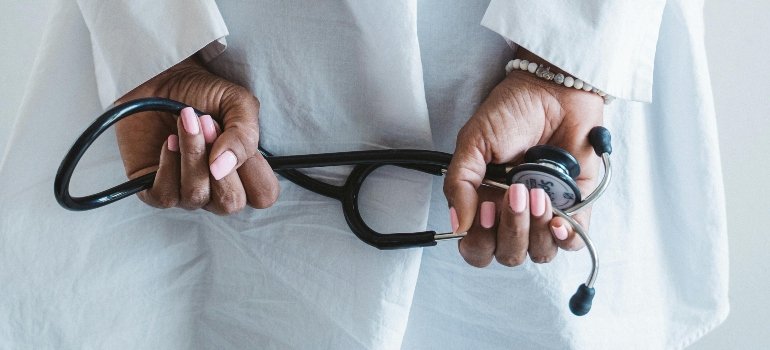 Healthcare professional with a stethoscope as medical costs are part of monthly expenses in Staten Island households