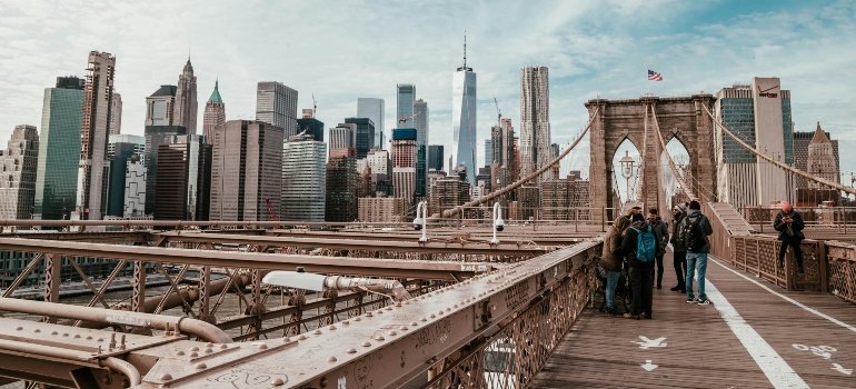 View of Brooklyn Bridge with the Manhattan skyline in the background, showcasing a key NYC landmark.