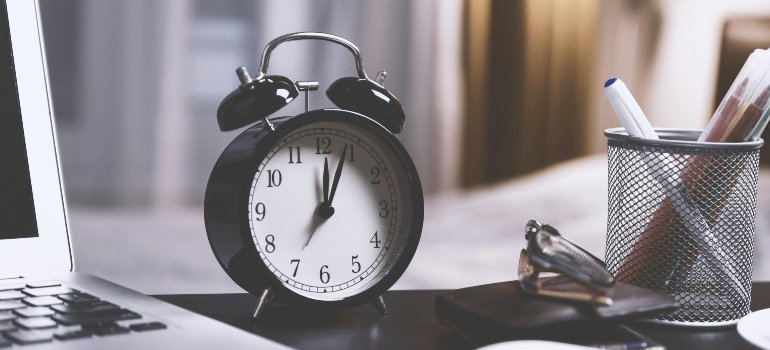 Close-up of an alarm clock on a desk, reminding you to make the right move when living in an overpriced city.