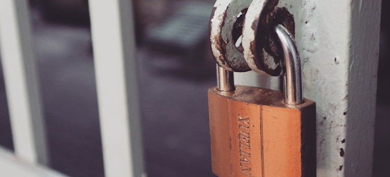 A lock on a gate as security is crucial when selecting a storage unit in Brooklyn.