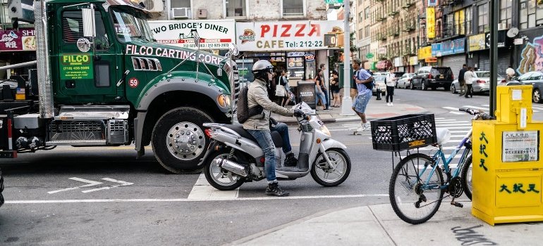 A person is riding a motorcycle scooter on the road.