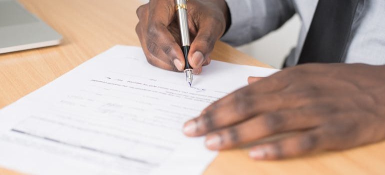 A person signing a contract.