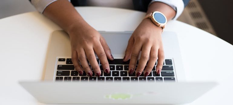 A person typing on a laptop.