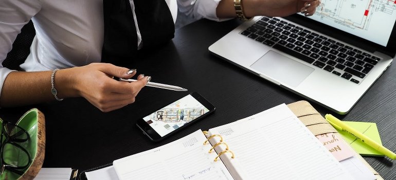 A real estate agent holding a pen while looking for profitable investment properties in Manhattan.